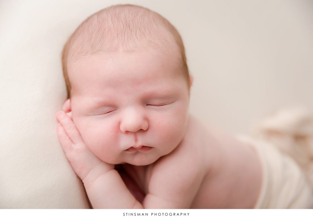 close up photo of baby boy in newborn session sleeping.