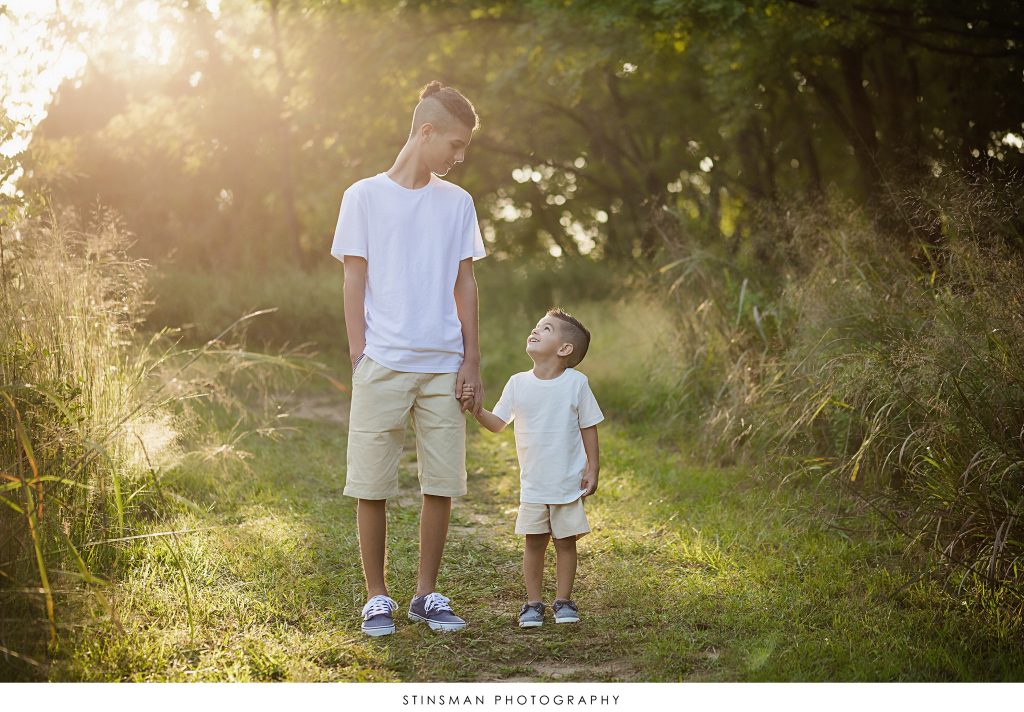 Brother's looking up and down at each other in south jersey family session.