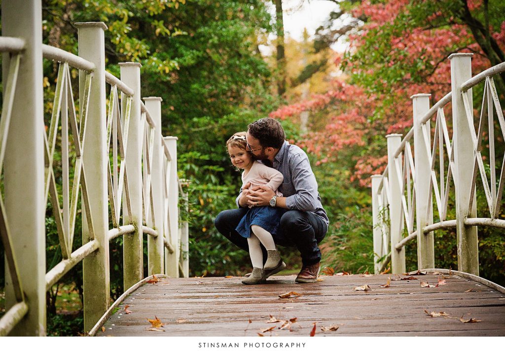 Father and daughter playing at their family photoshoot