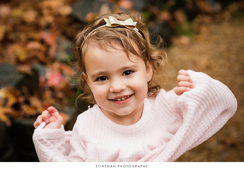 Little girl smiling at her family photoshoot