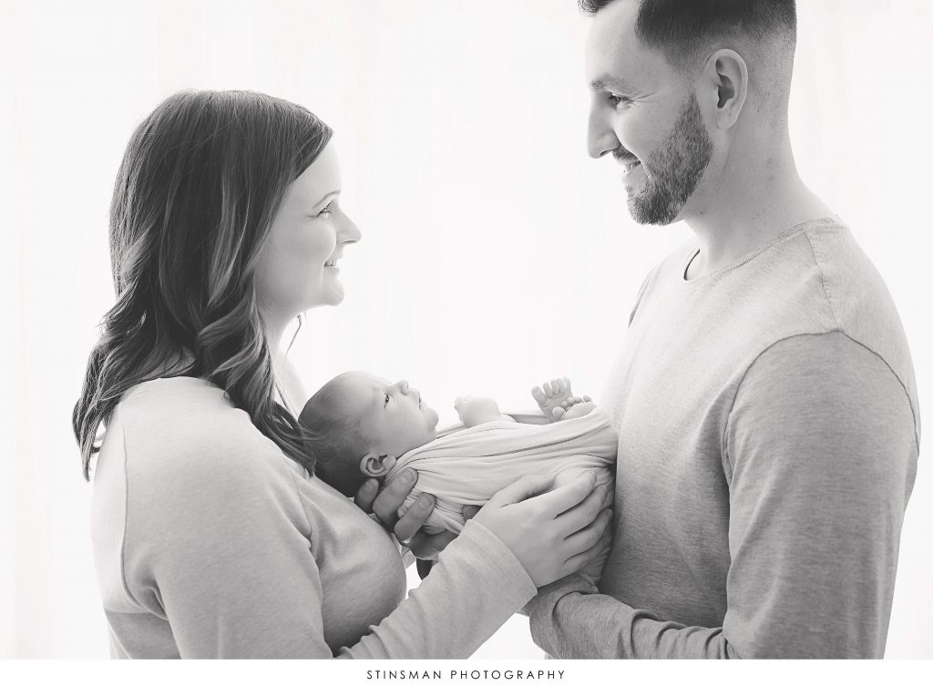 Mom and dad holding their newborn baby boy at their newborn session