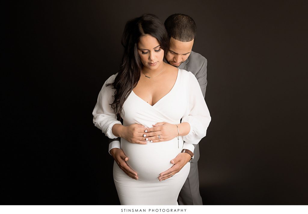 Pregnant mom and dad posed at their maternity photoshoot
