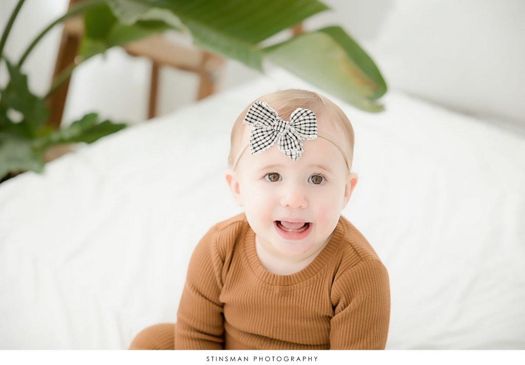 Baby girl smiling at her first birthday milestone photoshoot