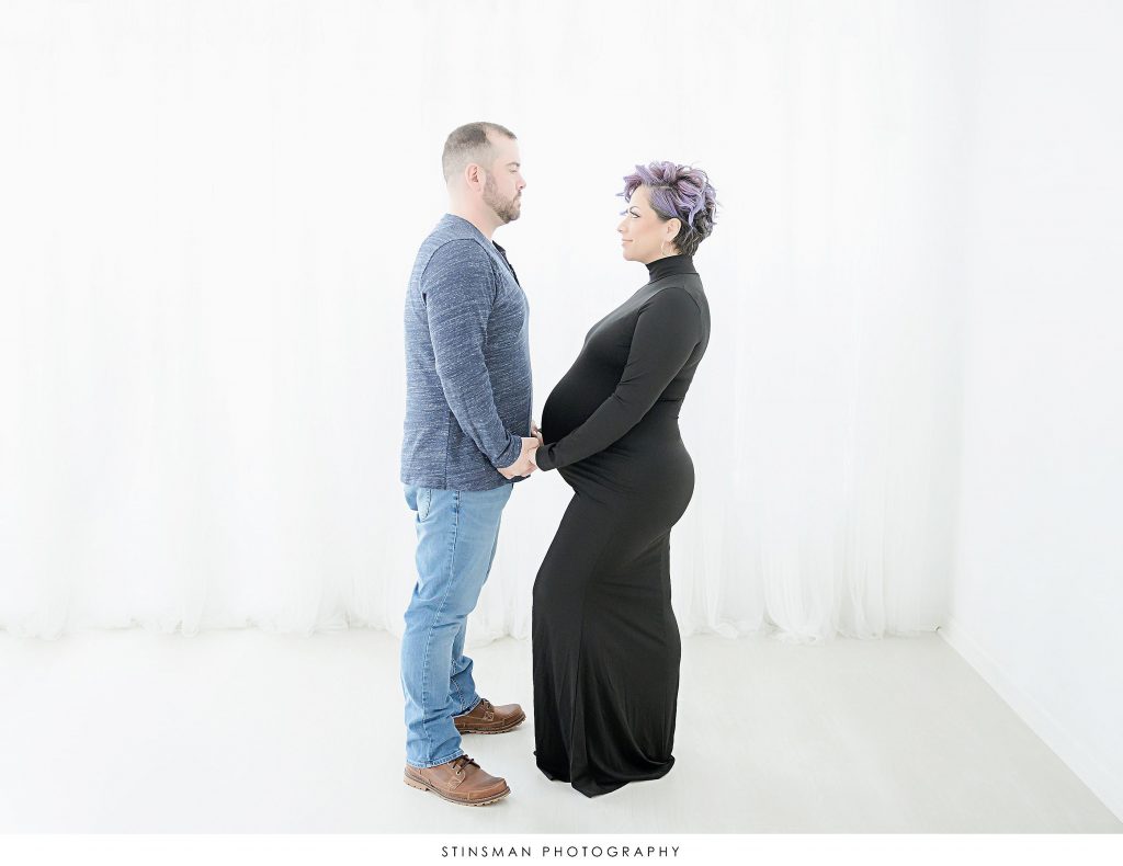 Pregnant mom and dad looking at each other at their maternity photoshoot