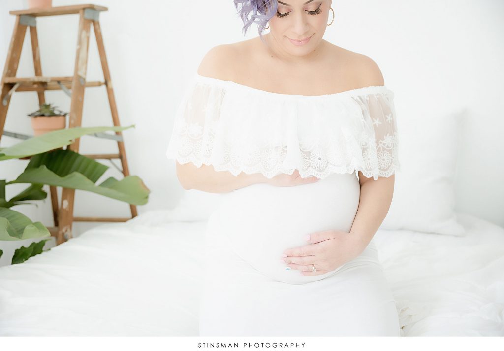 Pregnant mom holding her belly at her maternity photoshoot