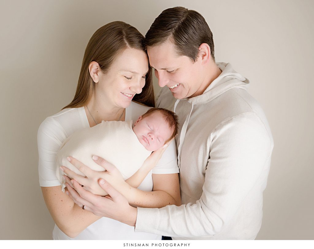 New parents holding their baby boy at their newborn photoshoot