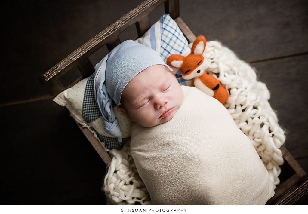 Newborn baby boy asleep at his newborn photoshoot