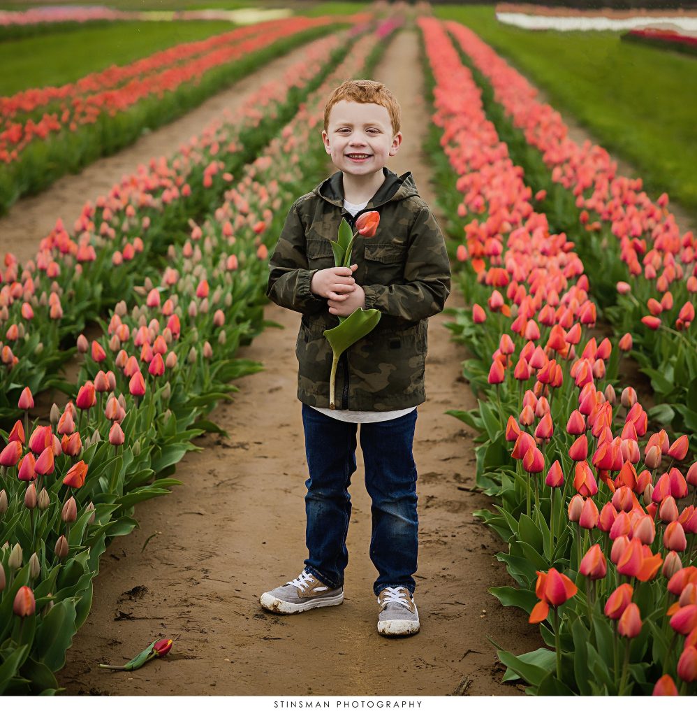Little boy smiling at his mini tulip photoshoot