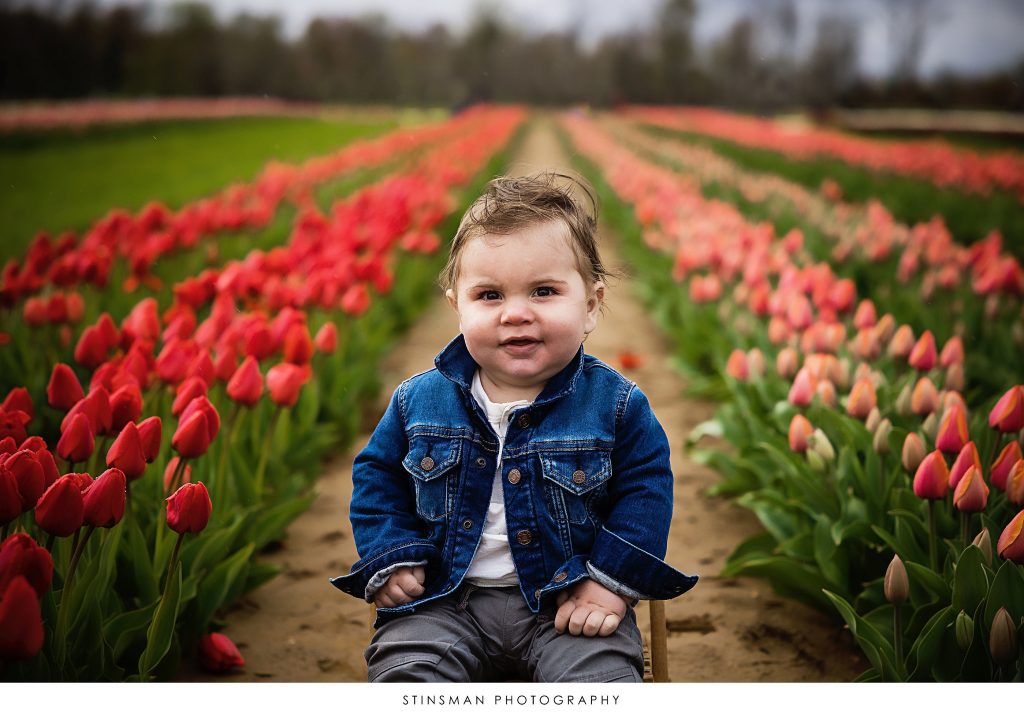 Baby boy smiling at his mini tulip photoshoot