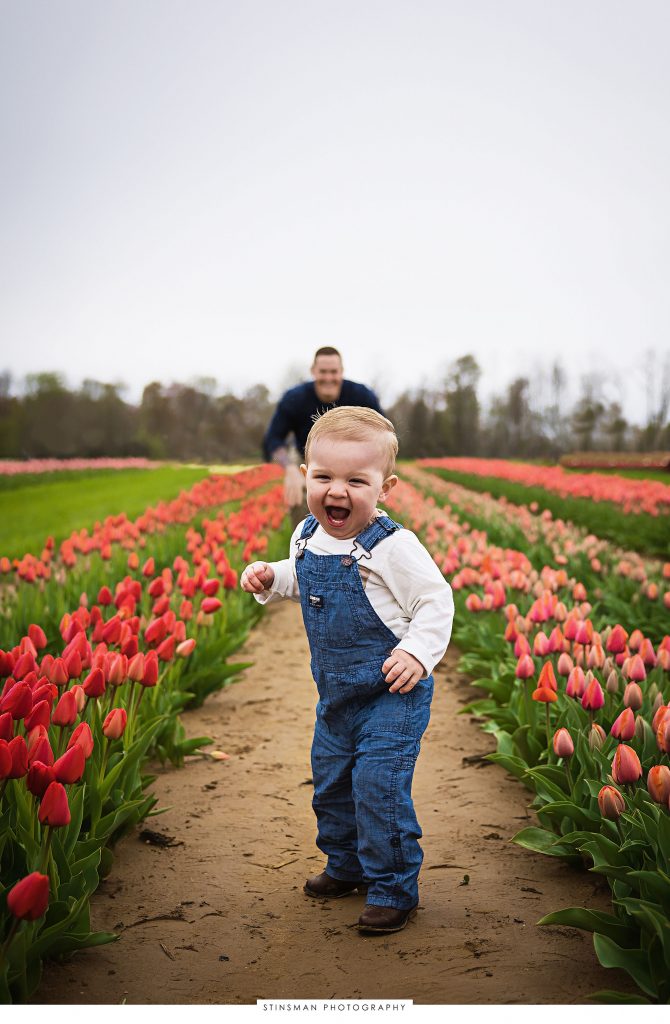 Little boy and dad playing at their mini tulip photoshoot