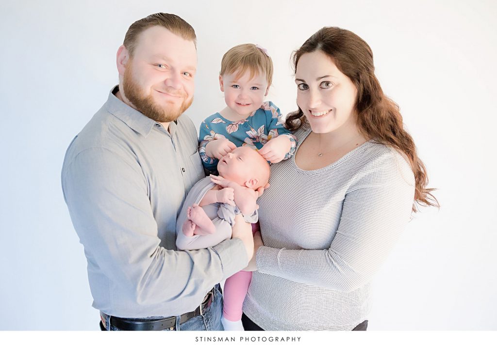 Family posing at their newborn photoshoot