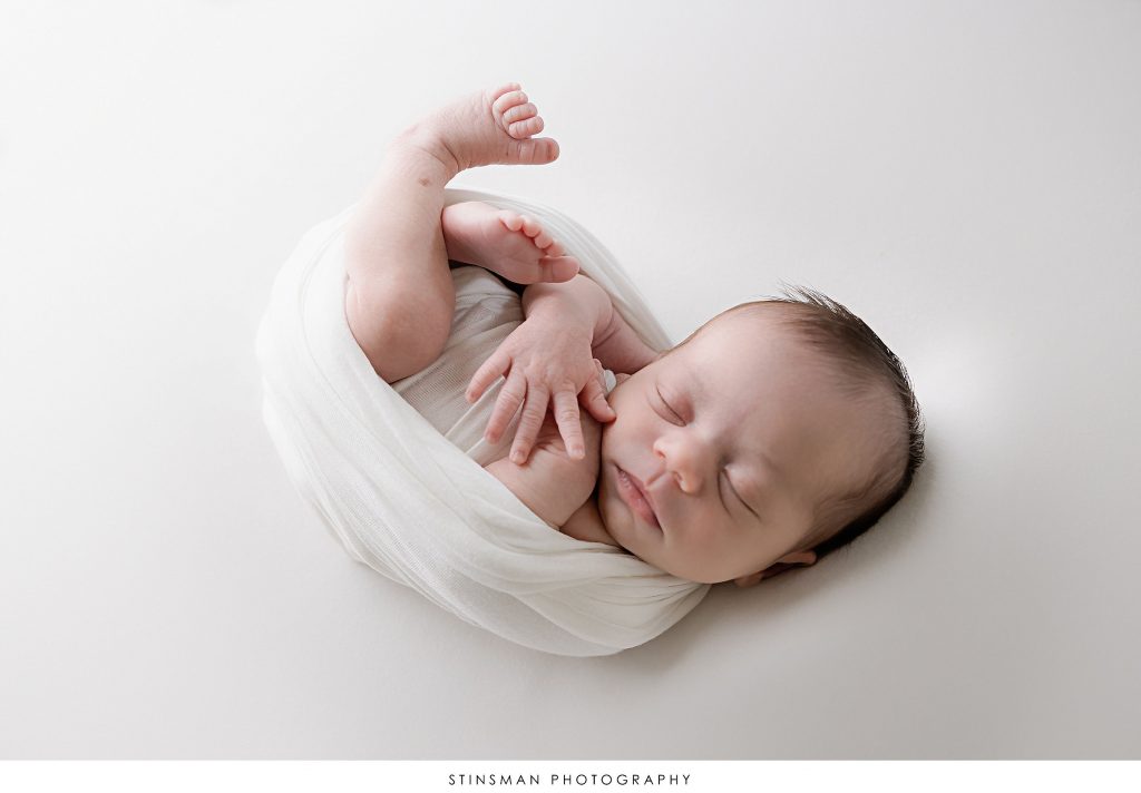 Newborn baby girl posed asleep at her newborn photoshoot