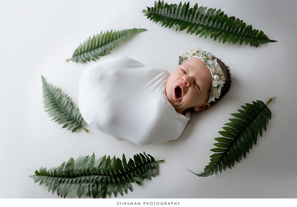Baby girl yawning at her newborn photoshoot