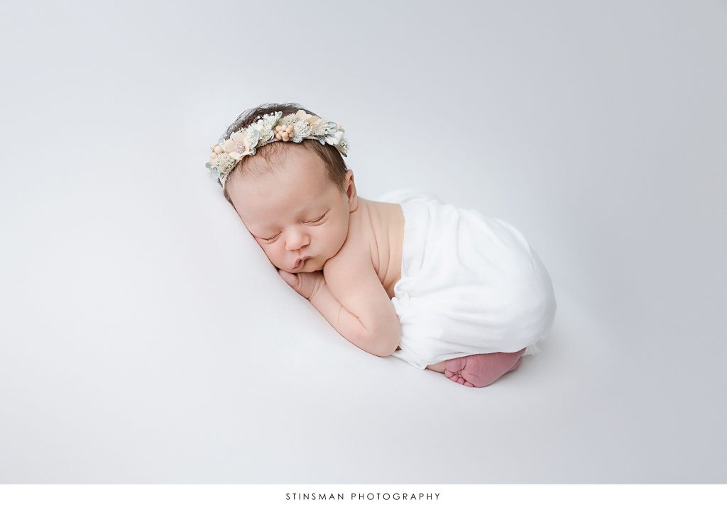 Newborn baby girl asleep at her newborn photoshoot