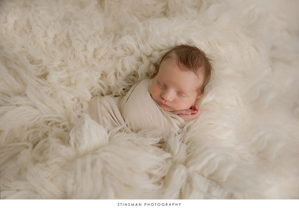 Newborn baby boy asleep at his newborn photoshoot