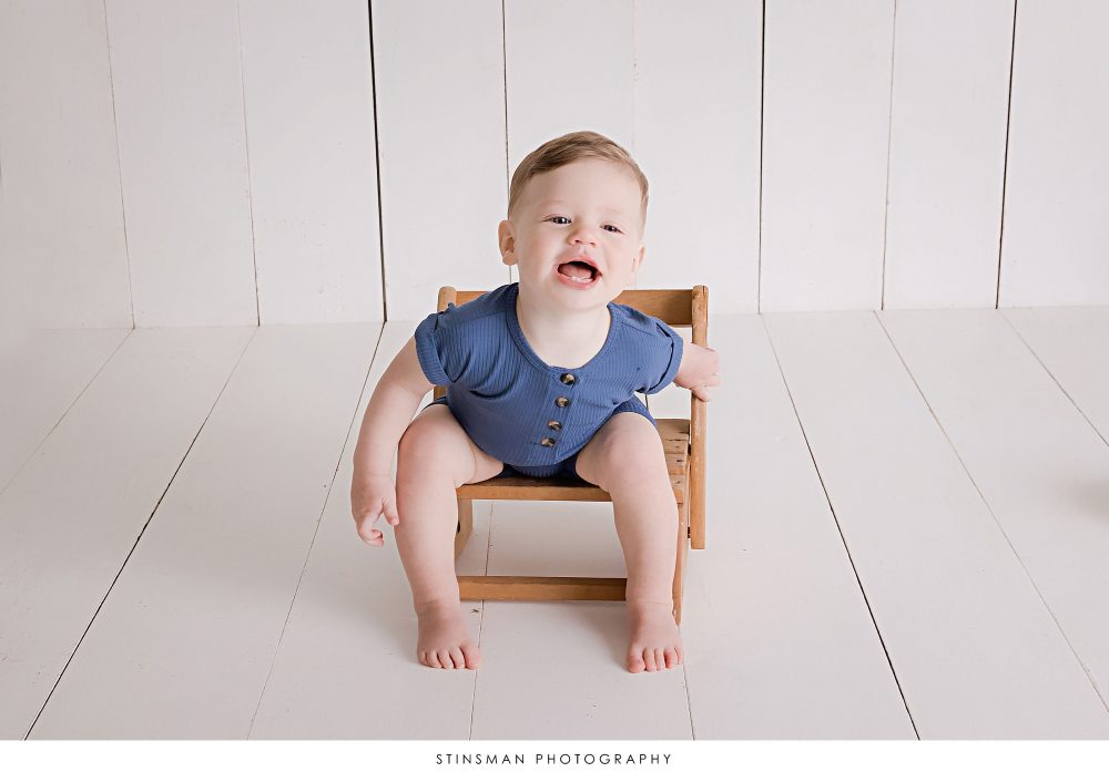 One year old boy posing at his milestone photoshoot