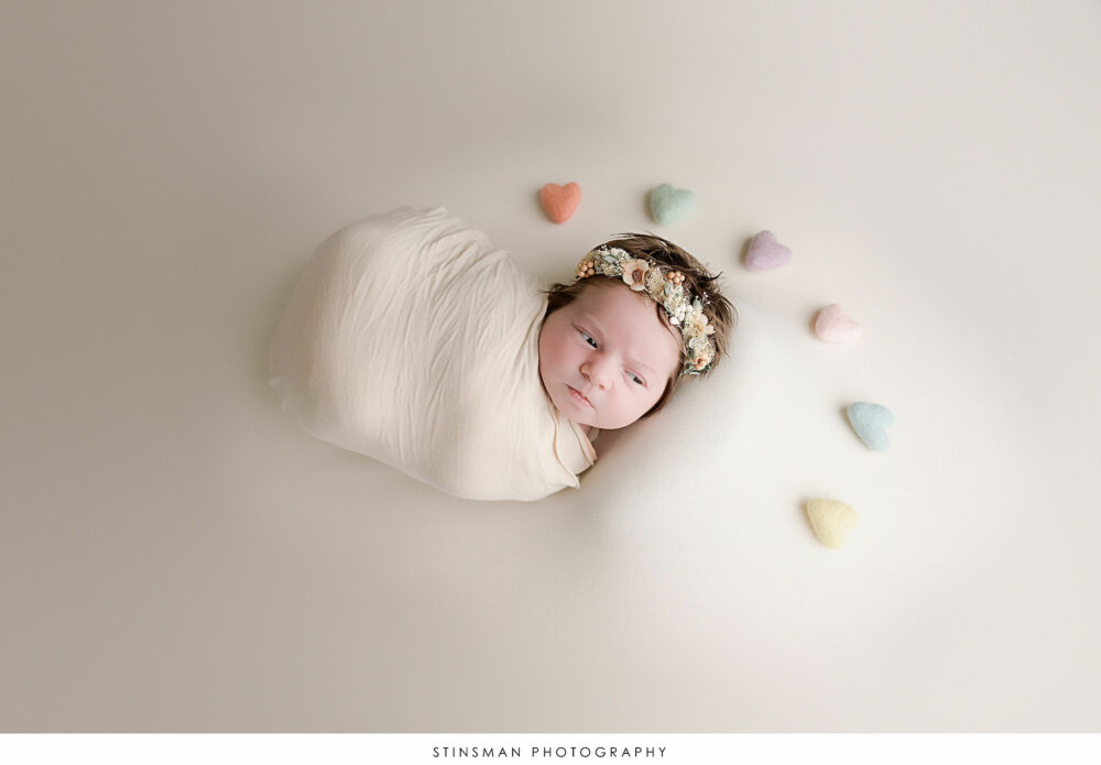Newborn baby girl posing at her newborn photoshoot