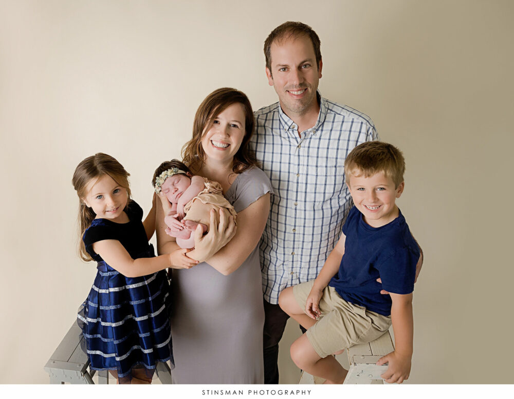 Posed family photo at baby girl's newborn photoshoot