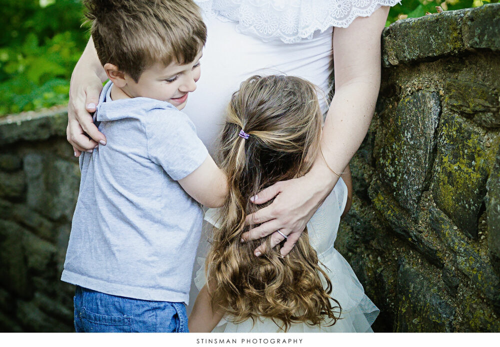 Son and daughter hugging mom's belly at mom's maternity photoshoot
