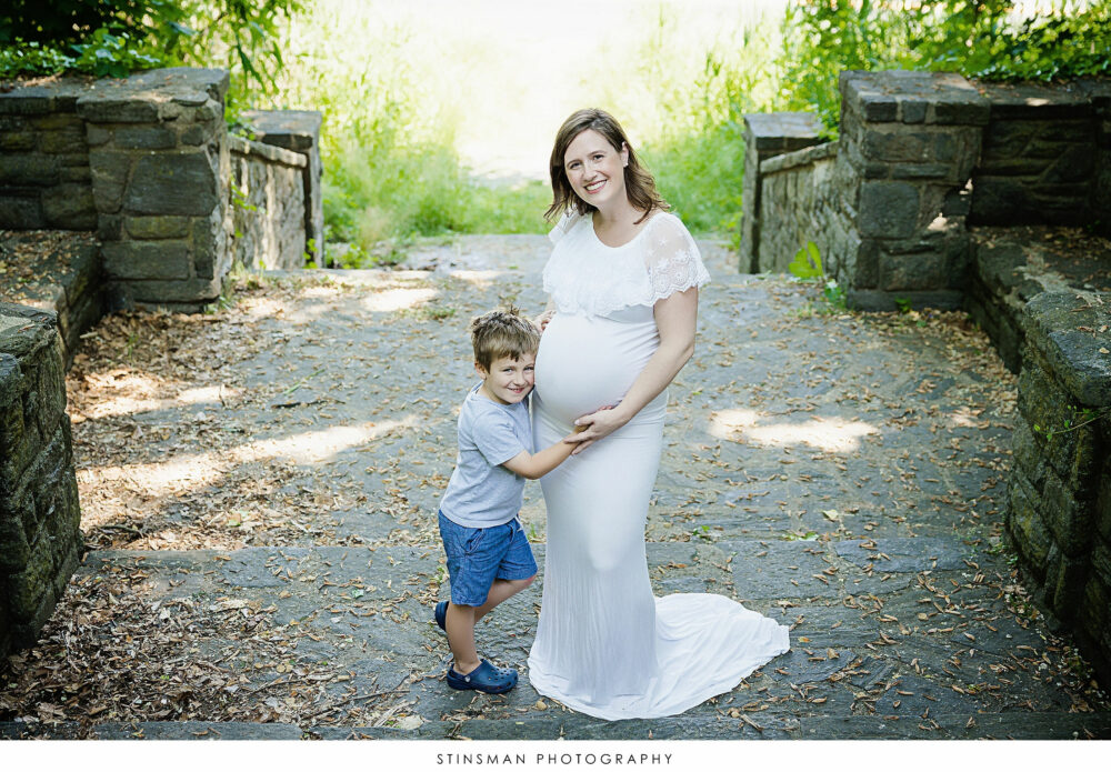 Mom and her son posing at her maternity session
