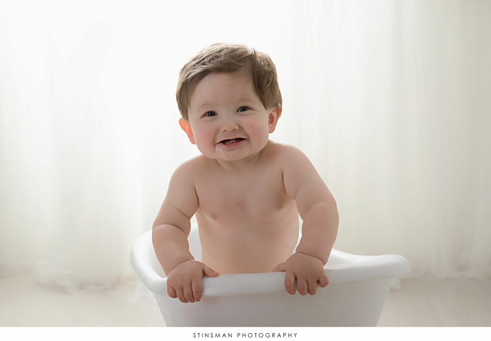 One year old boy posing at his milestone photoshoot