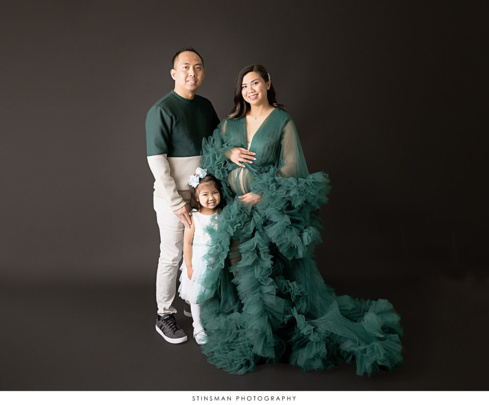 Pregnant mom with her family at her maternity photoshoot