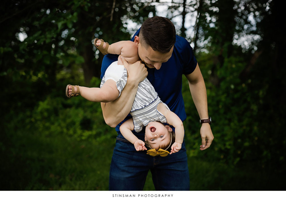 Dad and baby girl playing at milestone photoshoot