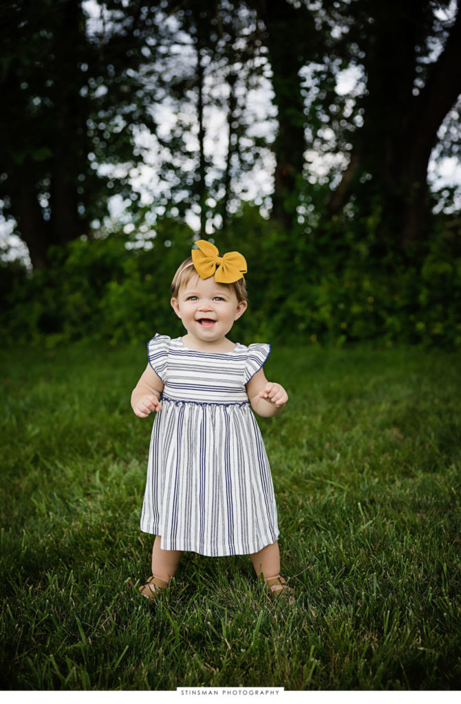 Baby girl posing at her milestone photoshoot