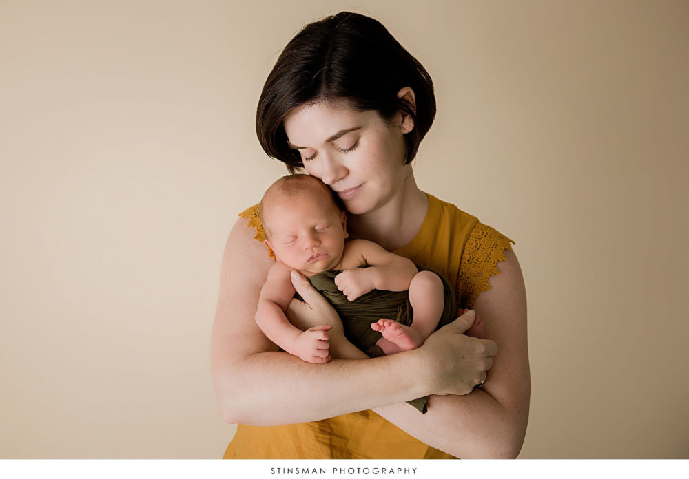 Newborn baby boy with his mom at his newborn photoshoot