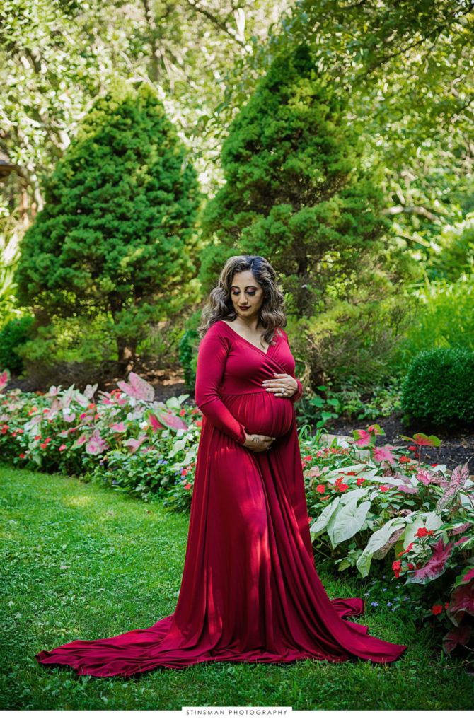 Pregnant mom in a red dress at her maternity photoshoot