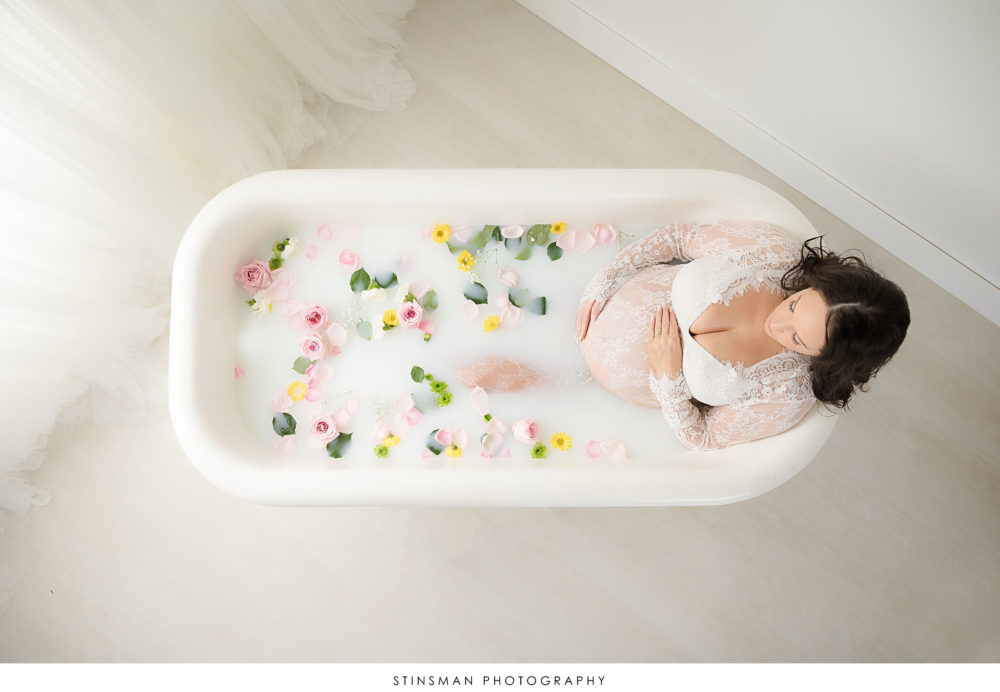 Pregnant mom in a milk bath at her maternity photoshoot