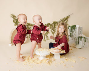 Twin sisters with their big sister posing at milestone photoshoot