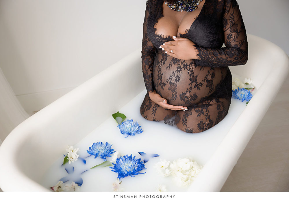 Pregnant mom in a milk bath at her maternity photoshoot