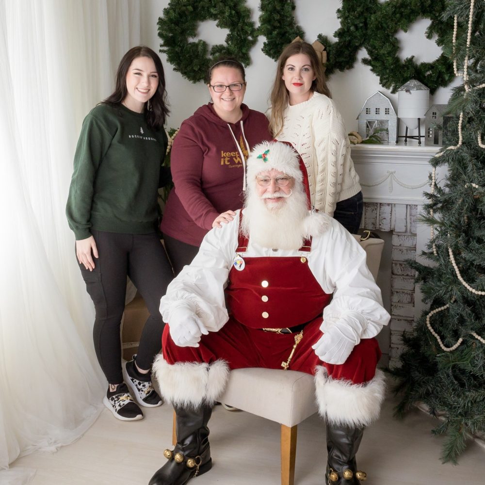 Jackie, Gina, and Olivia posing with Santa
