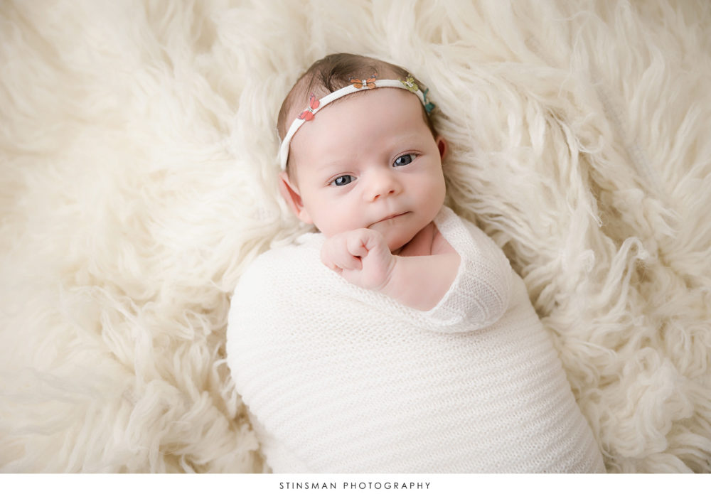 Newborn baby girl posed at her newborn photoshoot