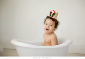 One year old girl playing at her milestone photoshoot