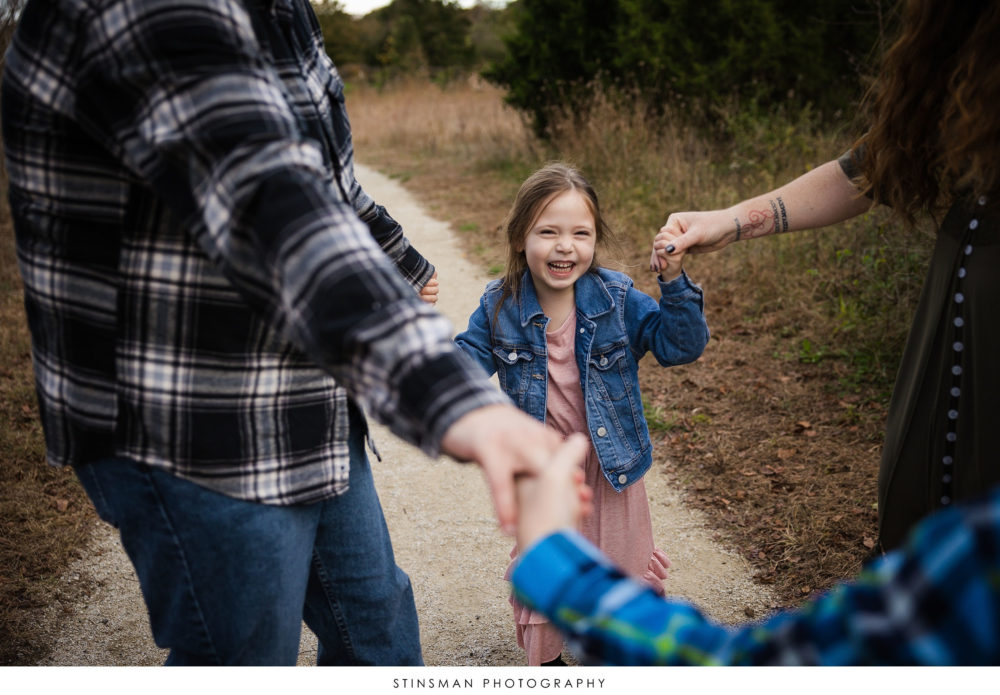 Little girl laughing at her family photoshoot