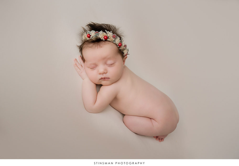 Newborn baby girl posed at her newborn photoshoot