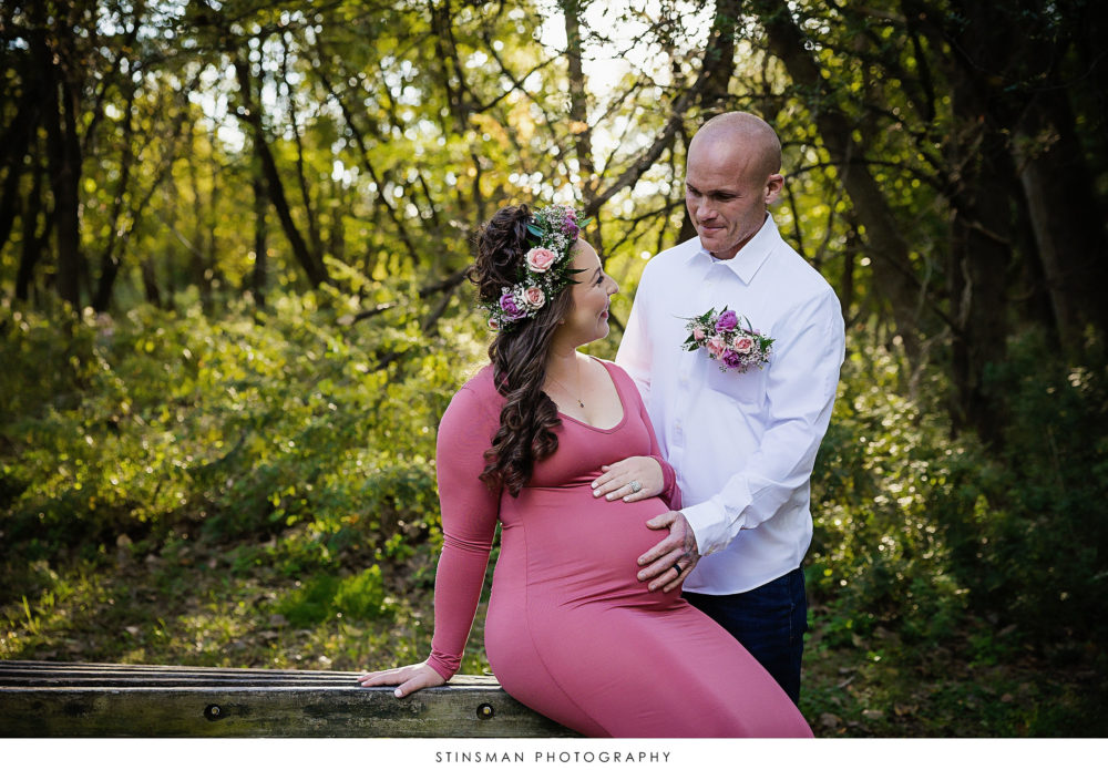 Pregnant mom and dad posing at their maternity photoshoot