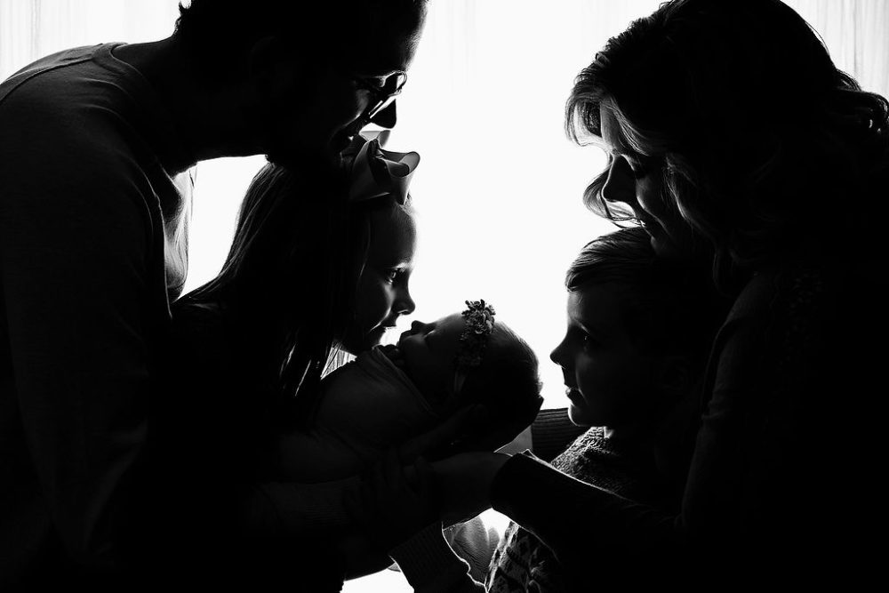 Family of five in black and white photo for in-studio newborn shoot in South Jersey