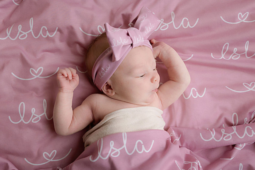 newborn baby girl with bowtie on blanket for baby pics in New Jersey.