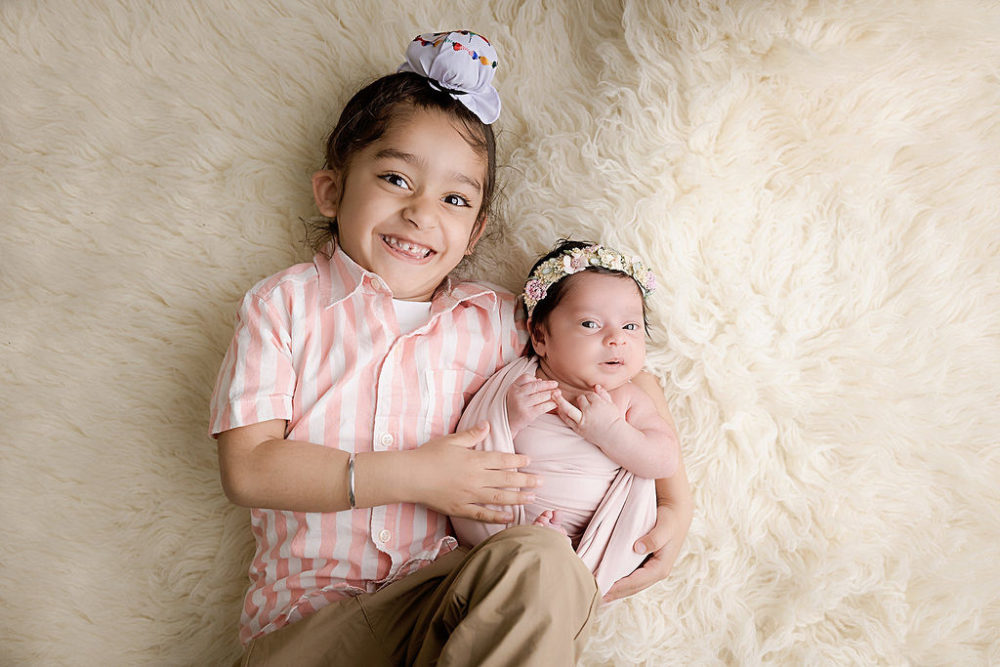 young boy and baby sister with matching colors for newborn shoot in South New Jersey