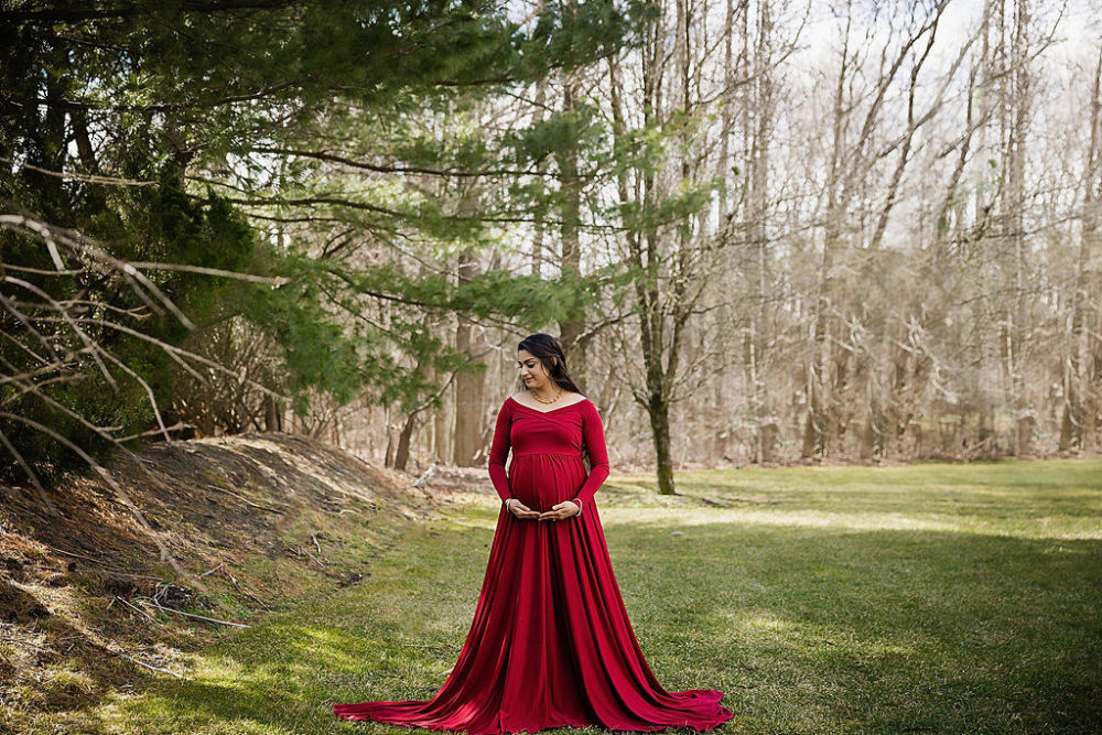 Mother wearing long sleeve maternity dress for in-home maternity session in south New Jersey.