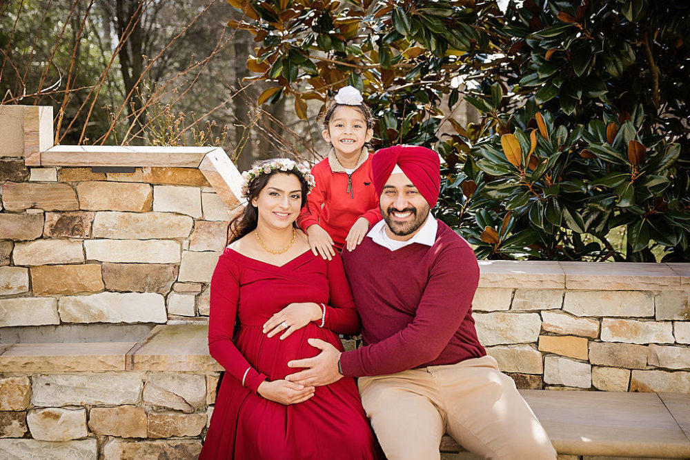 young boy, mom and dad smiling and wearing fall colors for in-home maternity session in Jobstown, New Jersey.