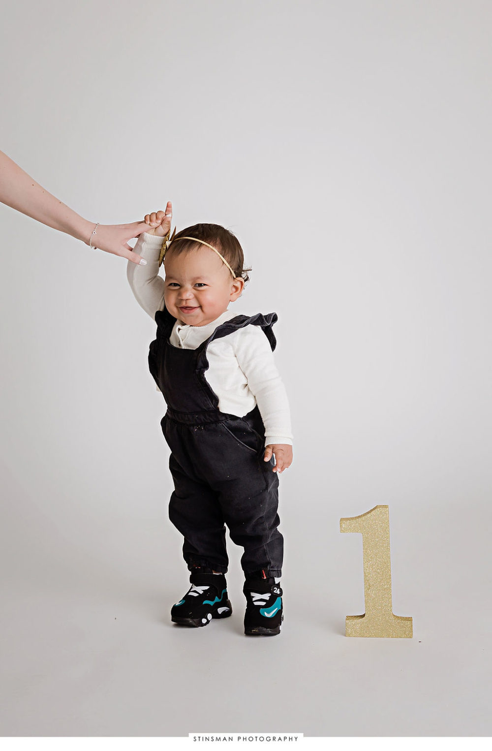 toddler girl wearing jumpsuit for her fashionable first birthday session in Trenton, New Jersey