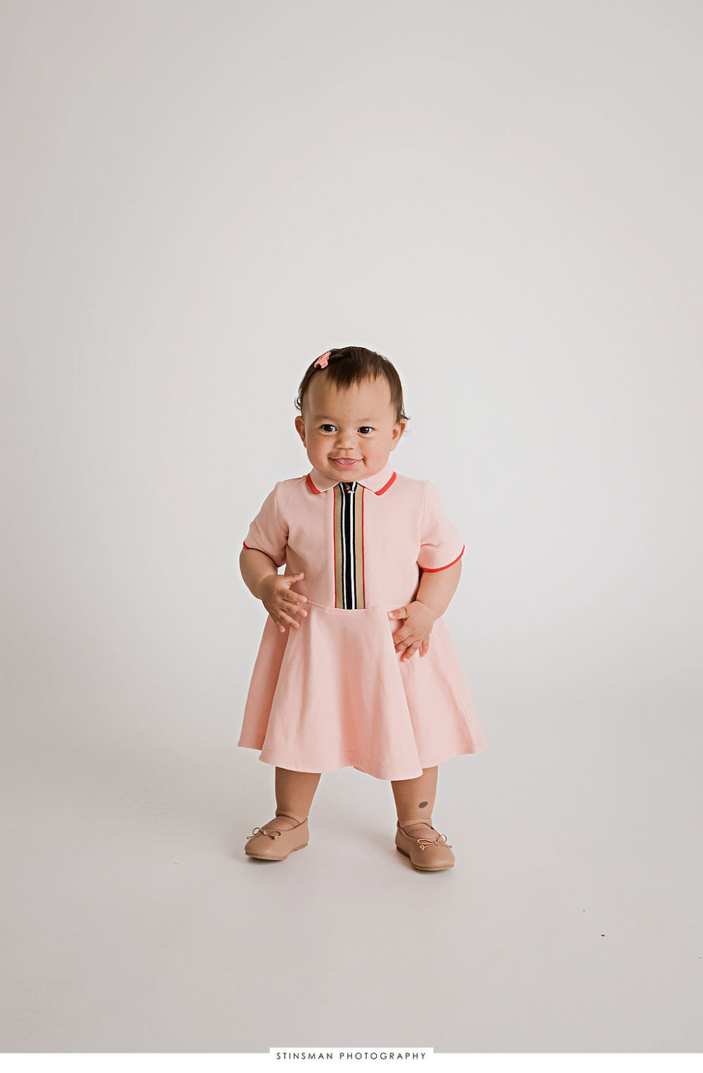 One year old wearing dress for her fashionable first birthday session in Hackensack, New Jersey.