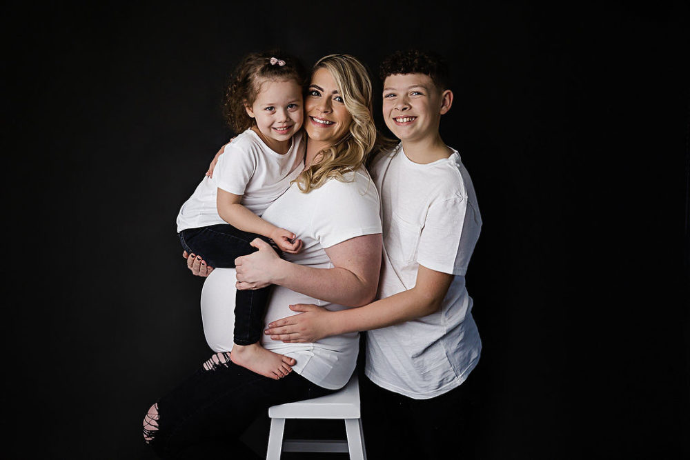 Mother and her two children for her black-and-white maternity and newborn session in Lakewood, New Jersey.