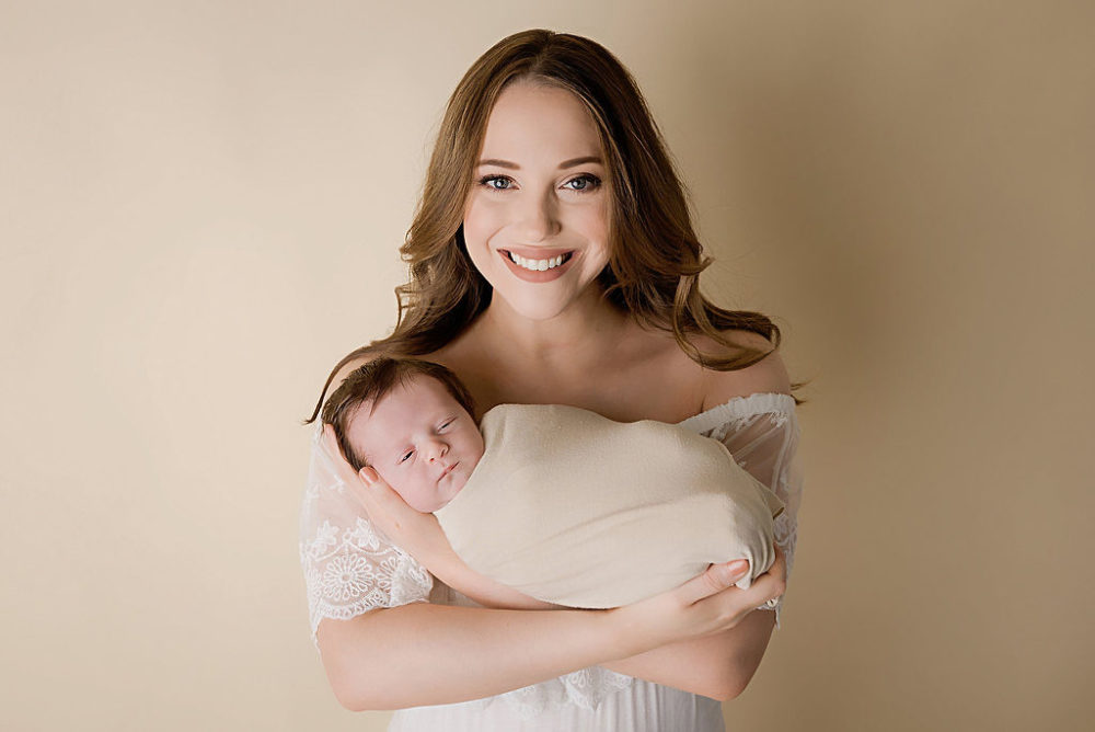 Mom holding son in arms for light and simple newborn session in Pemberton, New Jersey