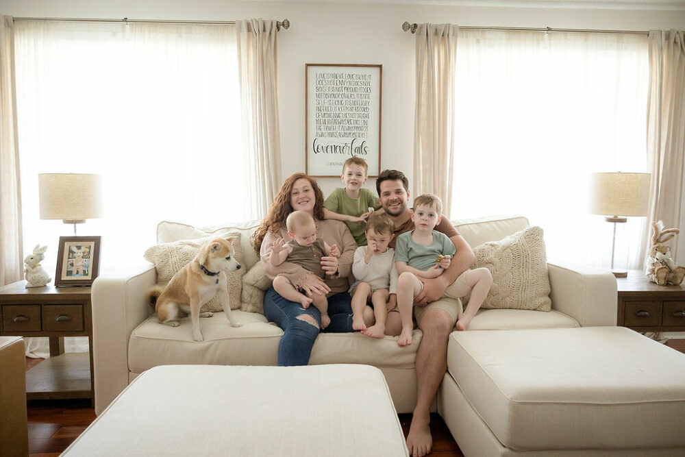 Family of six and dog smiling at camera for their lifestyle portraits in Hamilton, New Jersey.