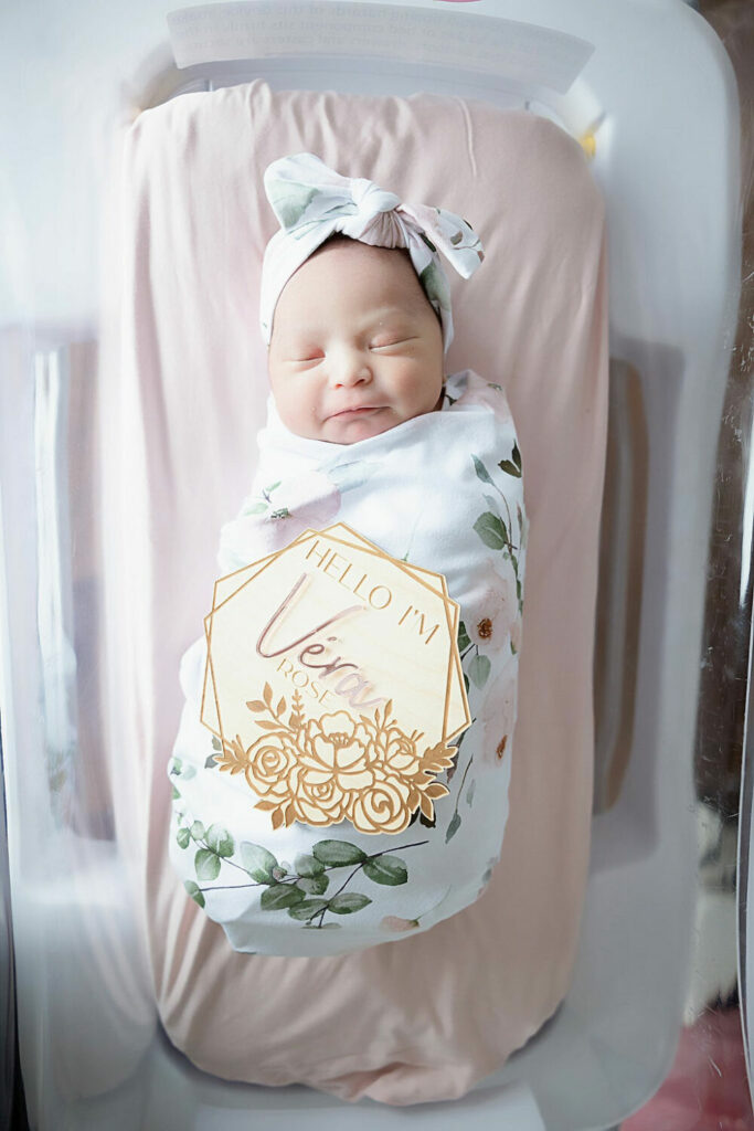 newborn girl in swaddle sleeping in bassinet for her Inspira Fresh 48 session in Woodbury, New Jersey.